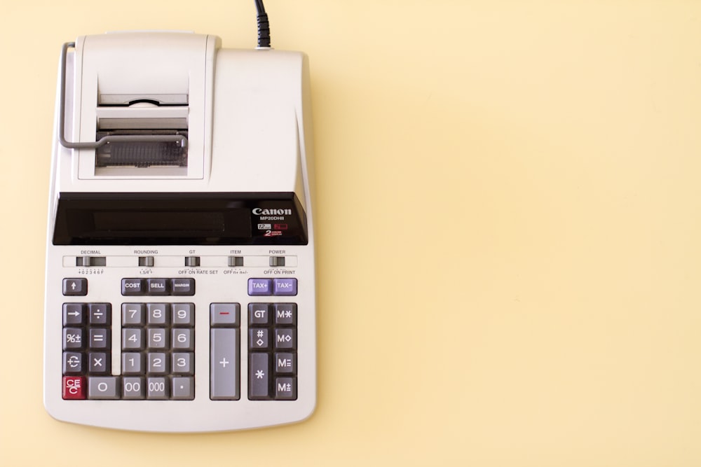 Overhead shot of a printing calculator on a yellow background
