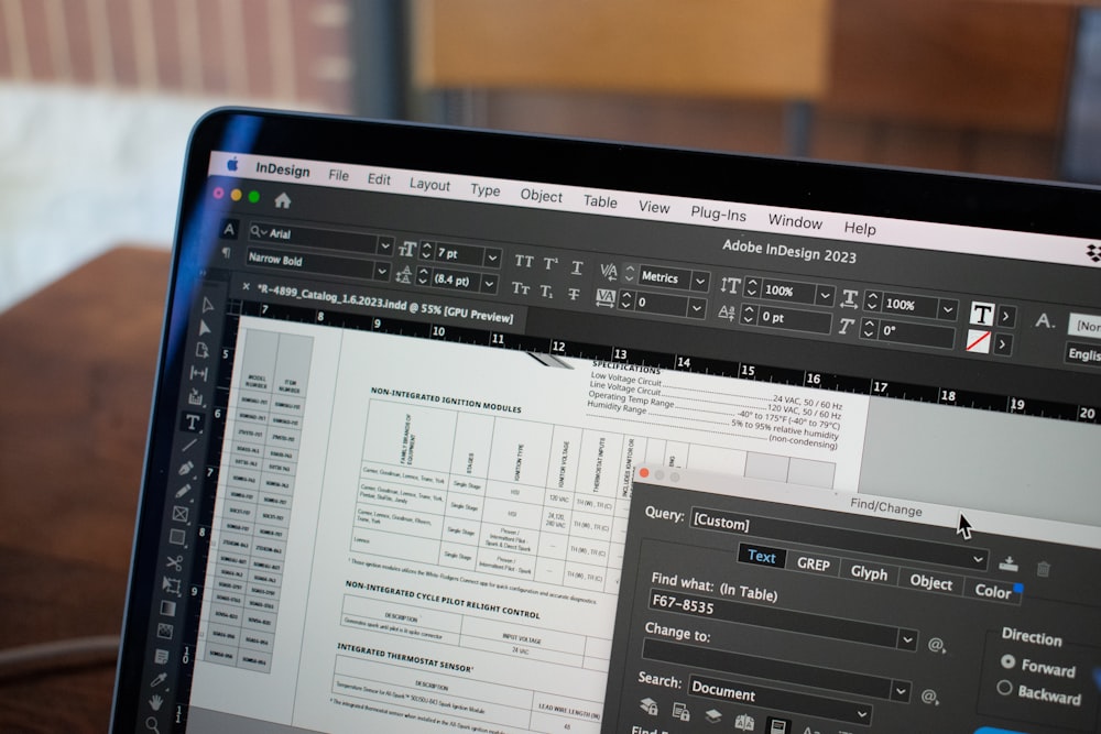 A laptop screen shows a software application displaying a document with text and tables, with a Find/Change dialog box open
